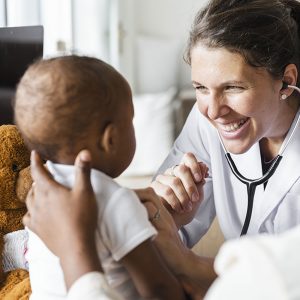 Pediatric doctor smiling with baby