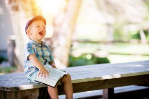 kid laughing and reading